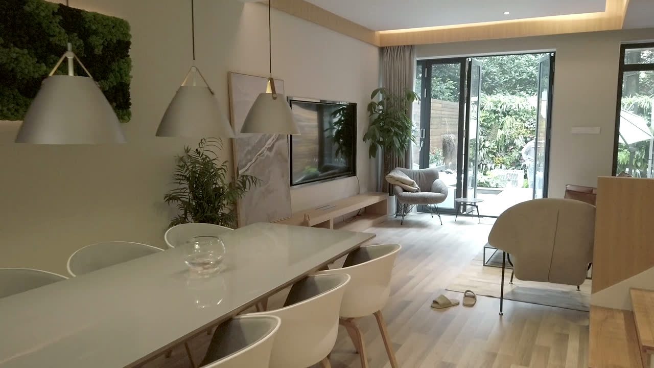 Ambient footage of a warm villa interior with a lounge chair and dining area.